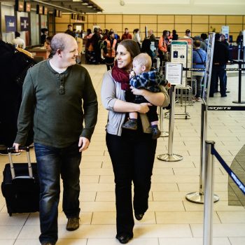 A couple walking by the check-in area at the airport