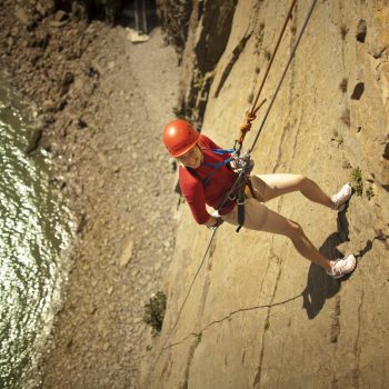 Person enjoying rock climbing at cape enrage rapelling