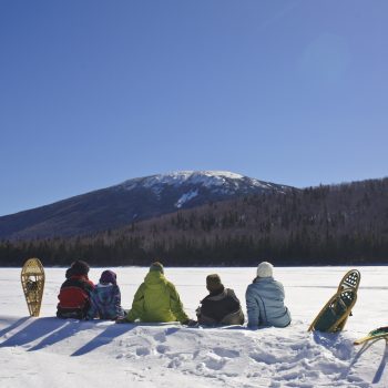 Snowshoers relaxing in snow