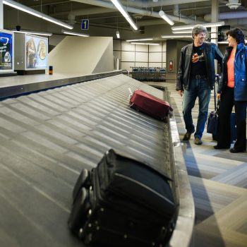 People waiting for the luggage on the baggage carousel