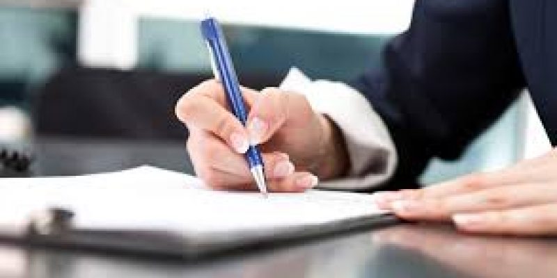 person writing on a notepad