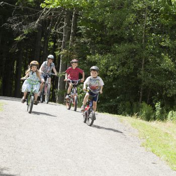A family cycling on a trail