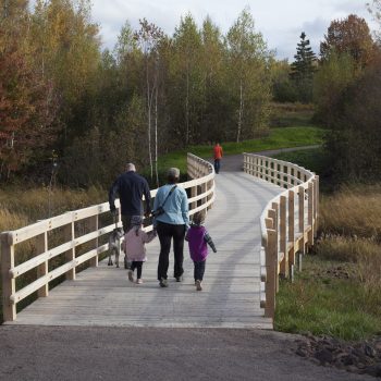 Family crossing a bridge