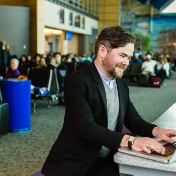 Man working on his laptop at the Moncton Airport