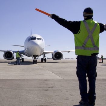 person guiding a plane