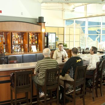 people drinking at a bar table